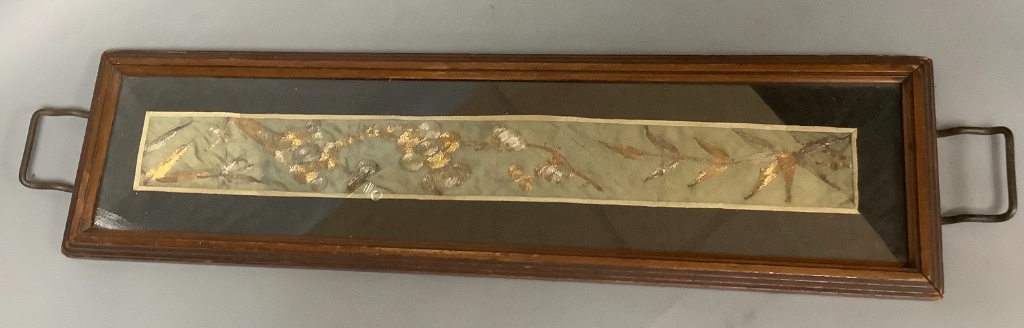 A Chinese gold couch work silk panel, mounted in a tray 62cm